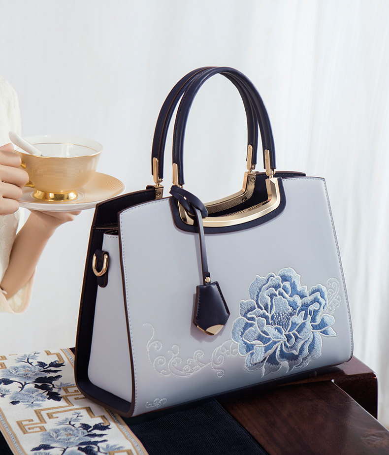 Ladies Elegant Burgundy Handbag with Floral Embroidery And Gold-Tone Hardware